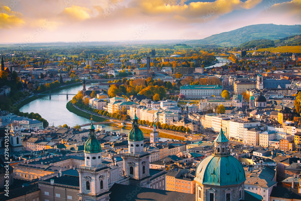 Beautiful of Aerial panoramic view in a Autumn season at a historic city of Salzburg with Salzach river in beautiful golden evening light sky and colorful of autumn at sunset, Salzburger Land, Austria
